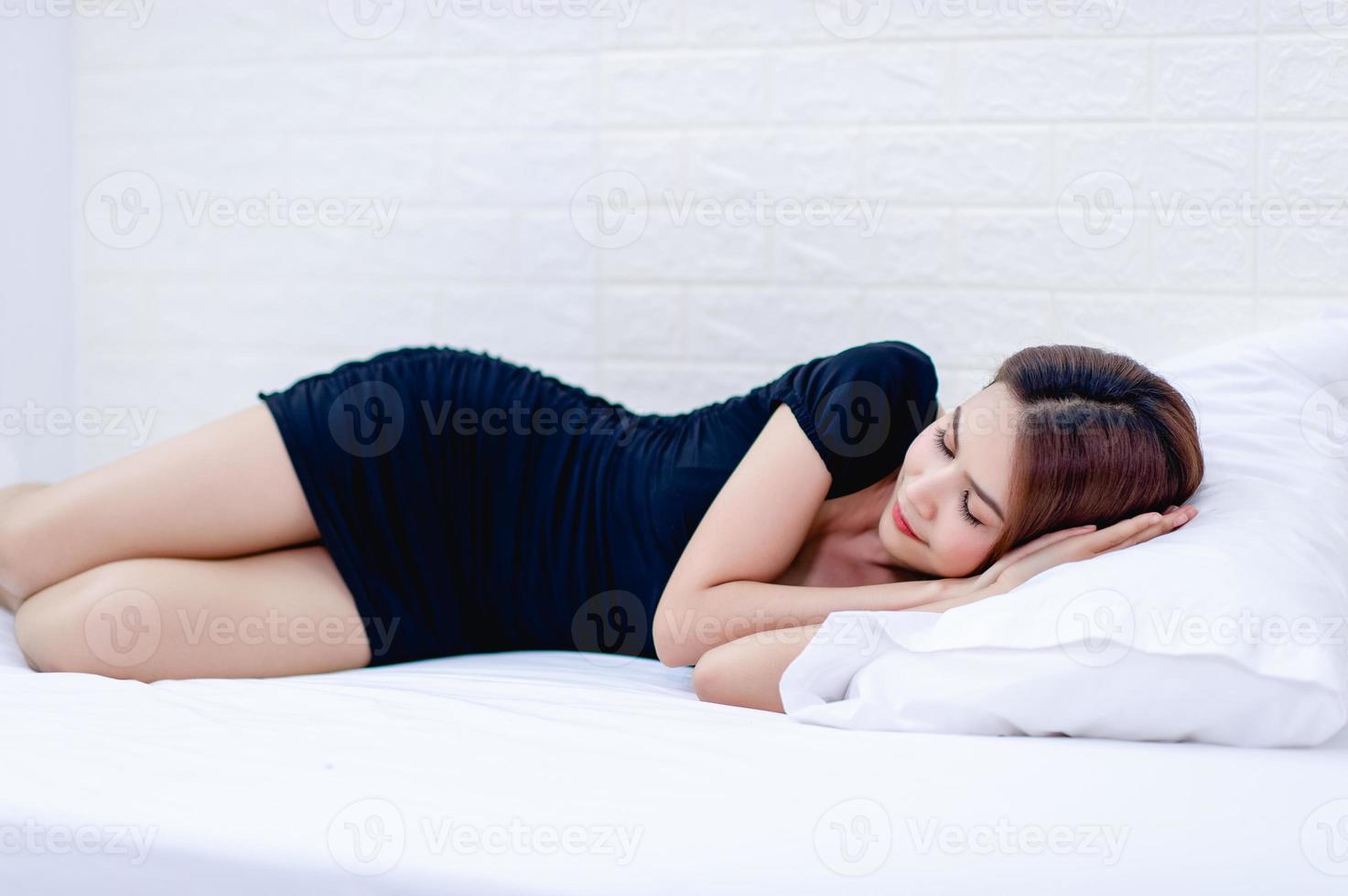 Woman and white mattress A sleepy woman Get enough rest. Health concepts photo