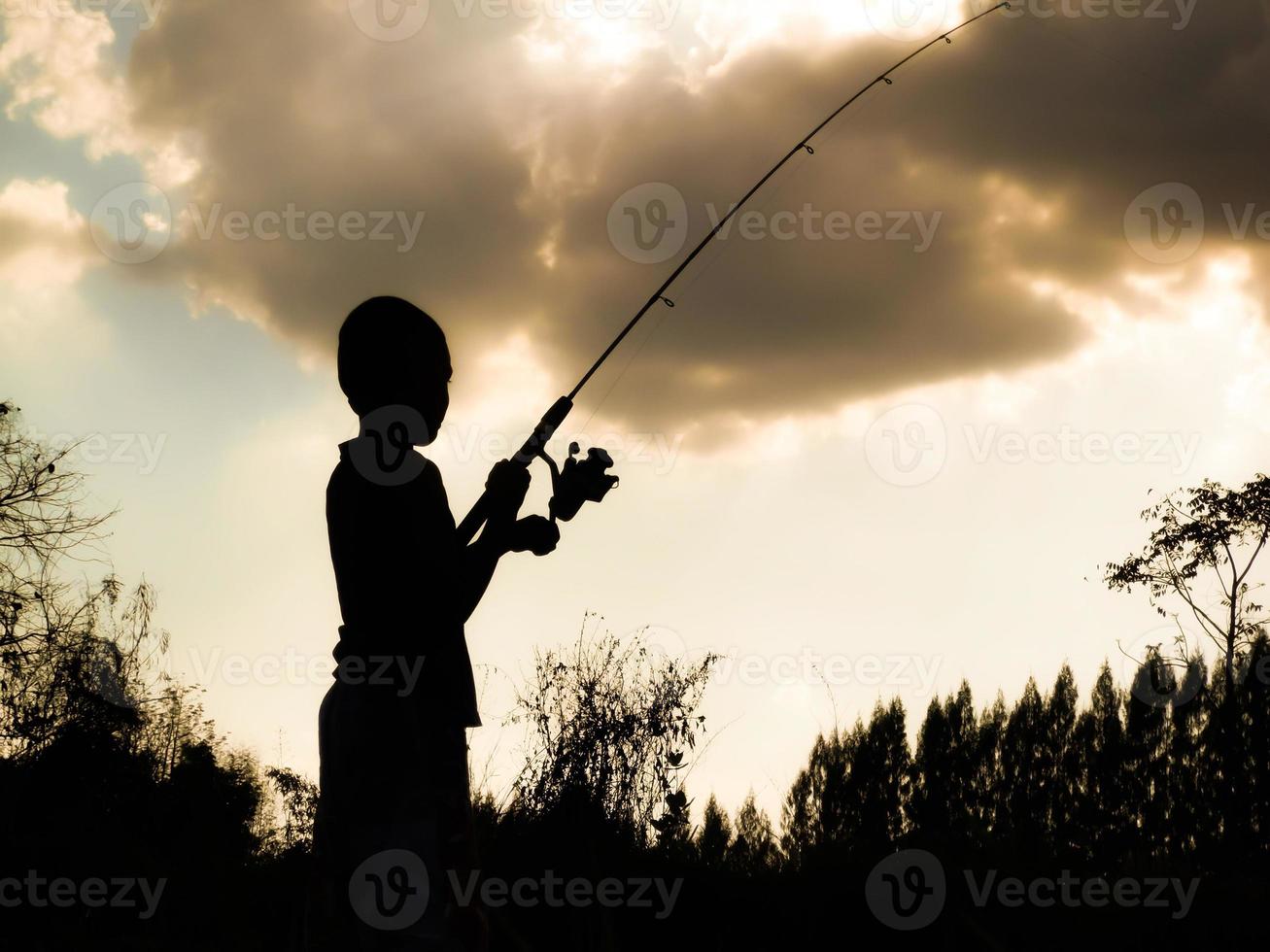 silhouette of a child fishing Children's happy time in the midst of nature  at sunset 6912163 Stock Photo at Vecteezy