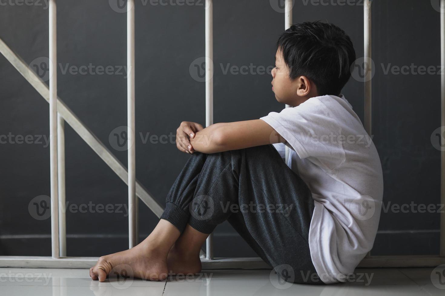 A young boy sitting alone with a sad feeling at home 6912230 Stock ...