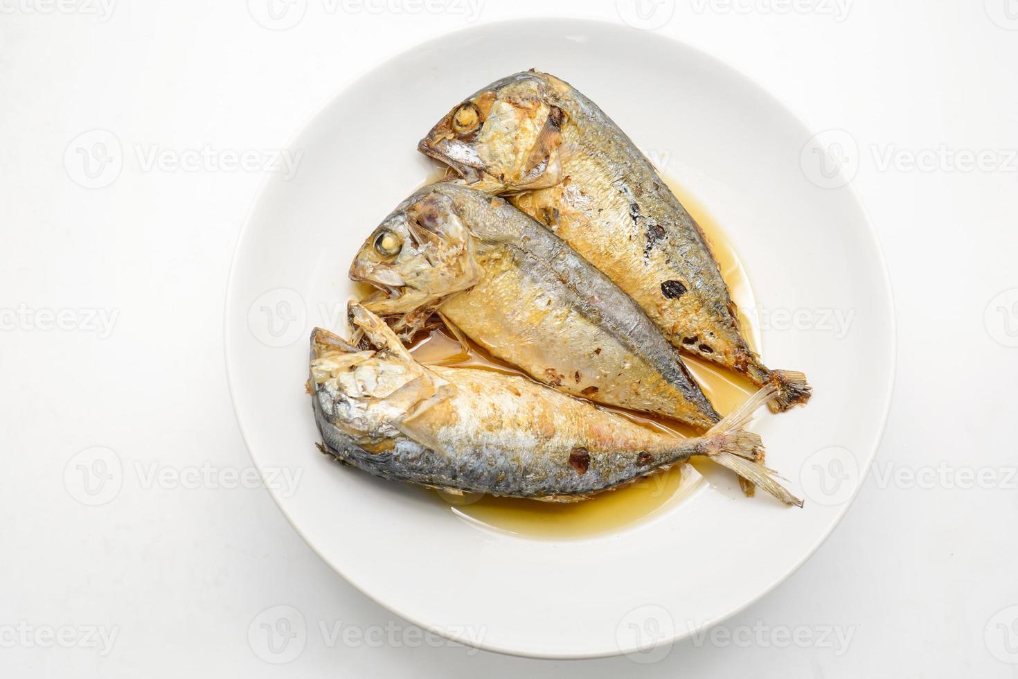 Fried mackerel on white plate. Deep fried fish photo