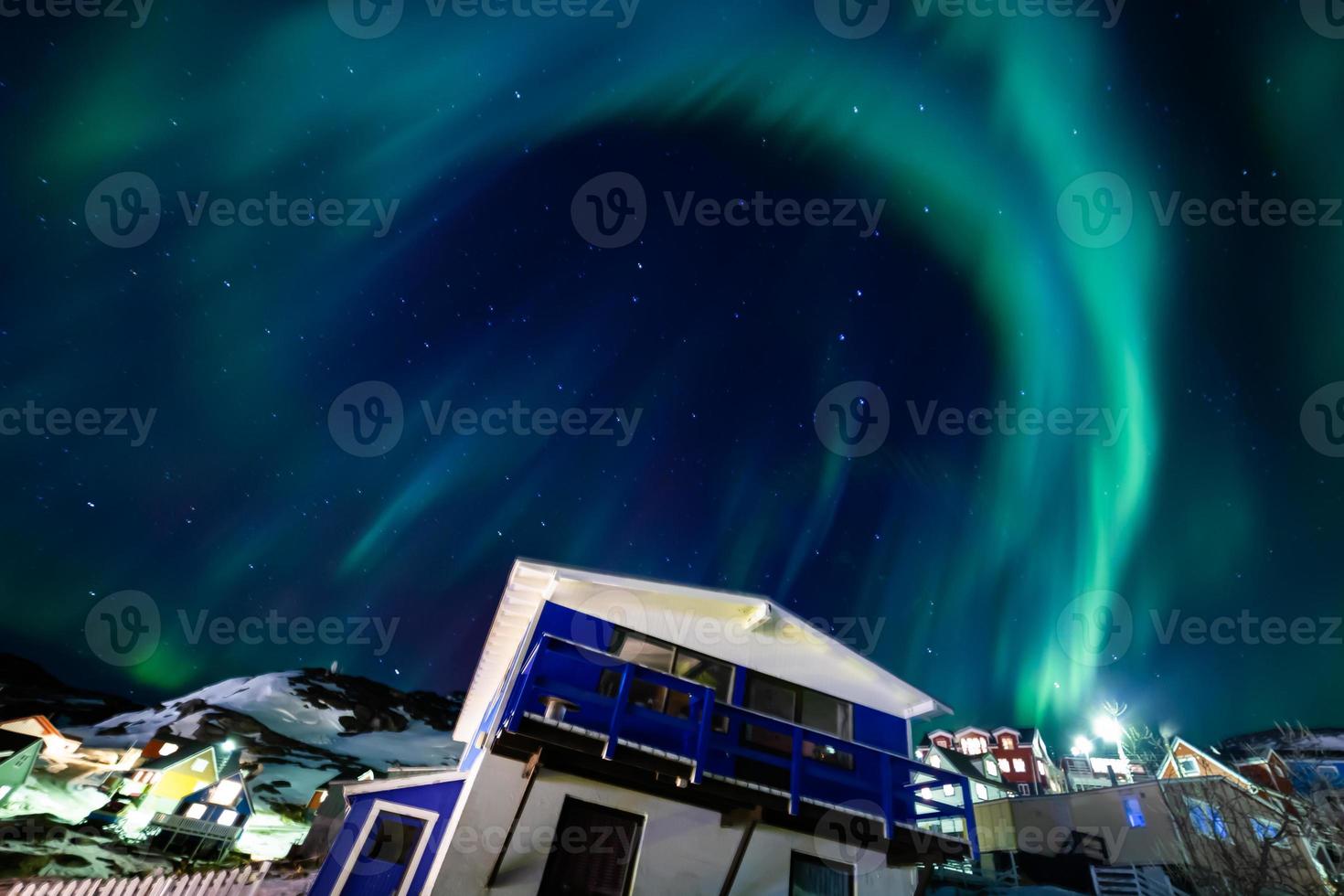 Beautiful aurola northen light over the town cityscap. Northen lights in south kitaa Qaqortoq Greenland photo