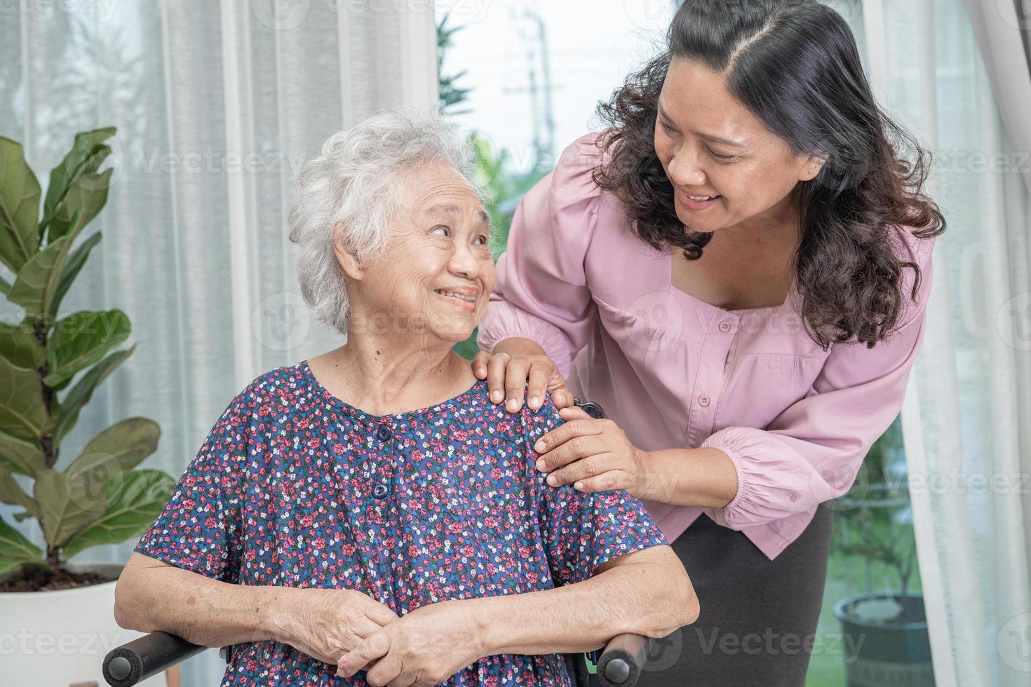 Help Asian senior or elderly old lady woman sitting on wheelchair and wearing a face mask for protect safety infection Covid 19 Coronavirus. photo