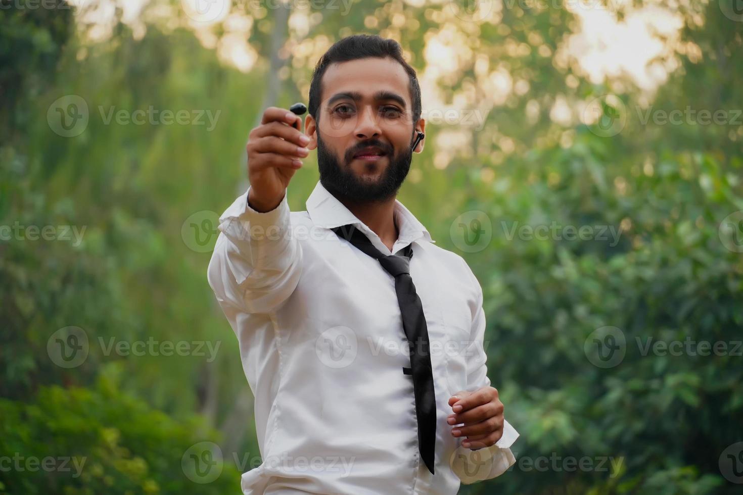 Man showing wireless earbuds - device accessory. new technology. photo