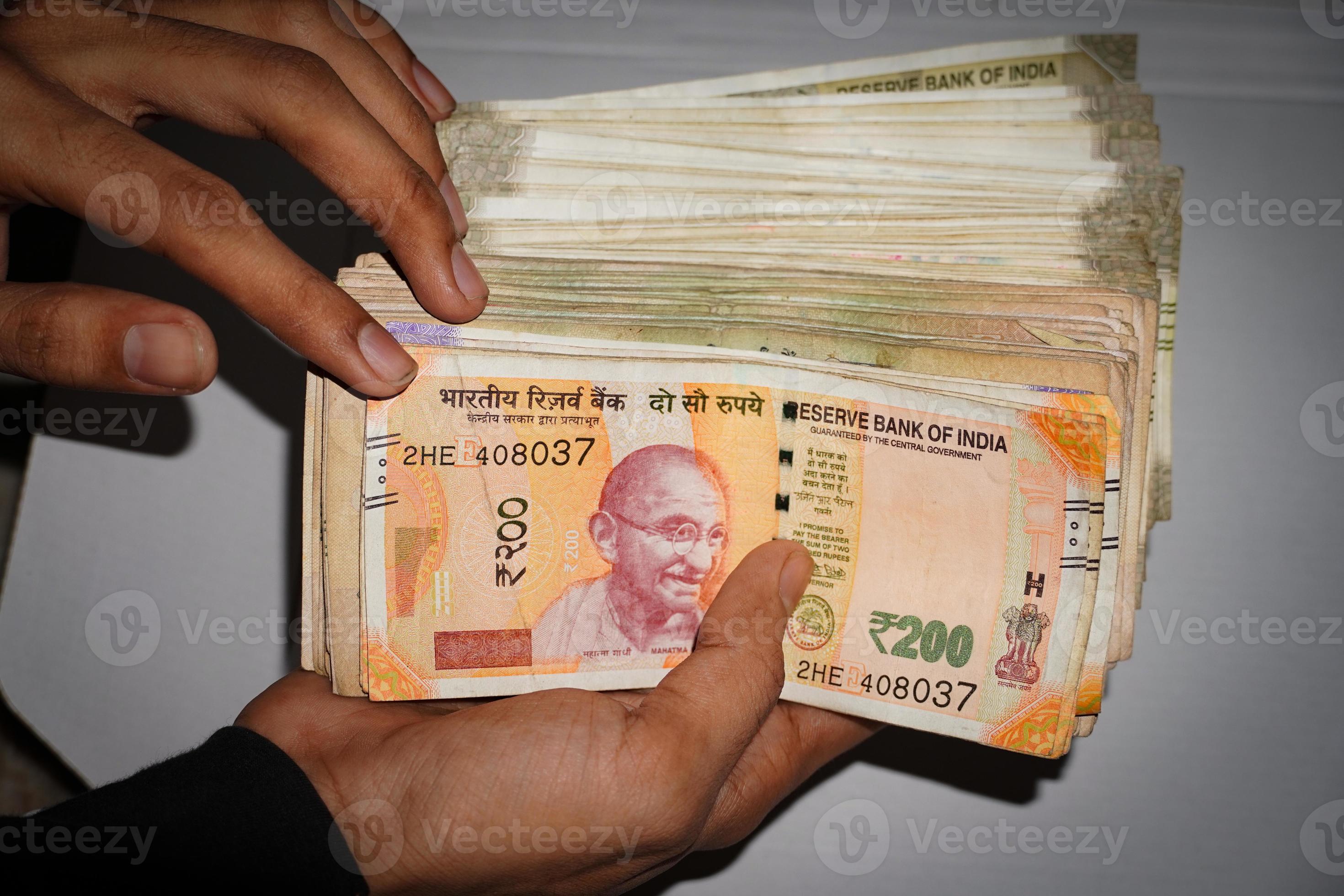 indian-currency-images-in-hand-200-rs-notes-and-500-rs-notes-6914014