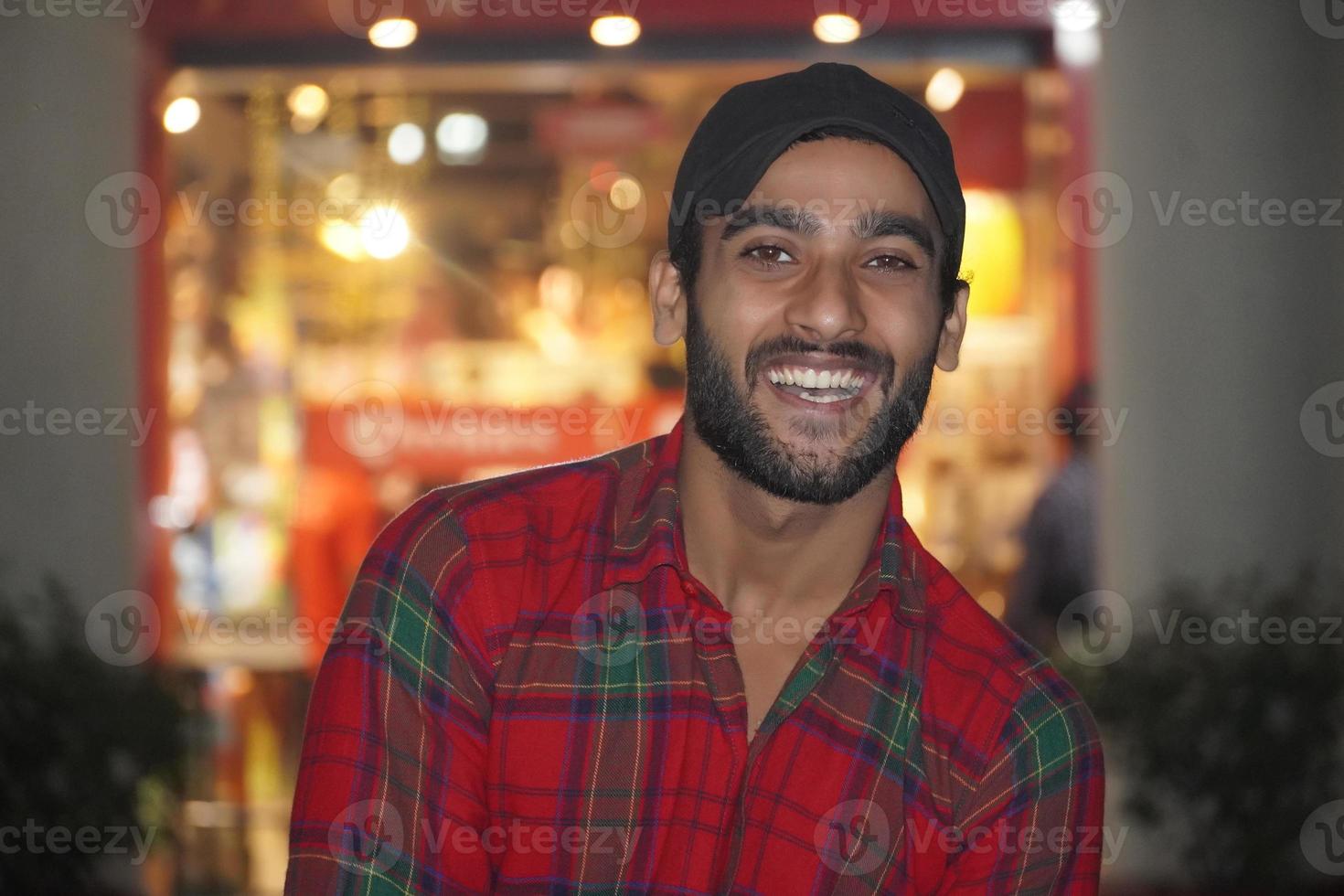 man with beautiful smile in night light photo