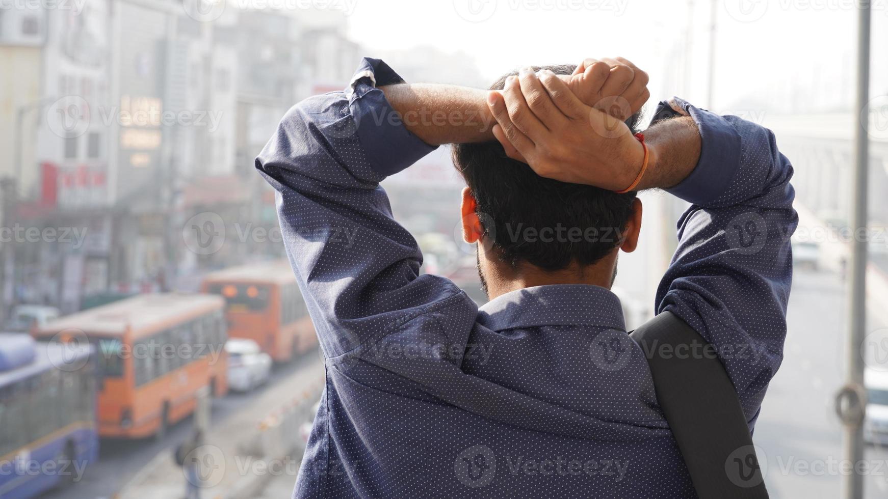 sad and confused man in suit is enjoying the view of the city photo