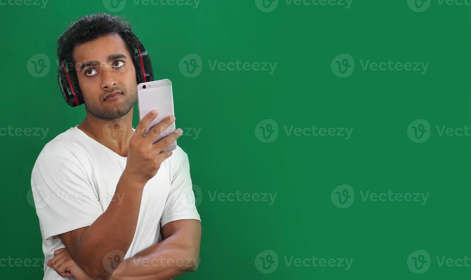 Young man using mobile phone but not happy photo
