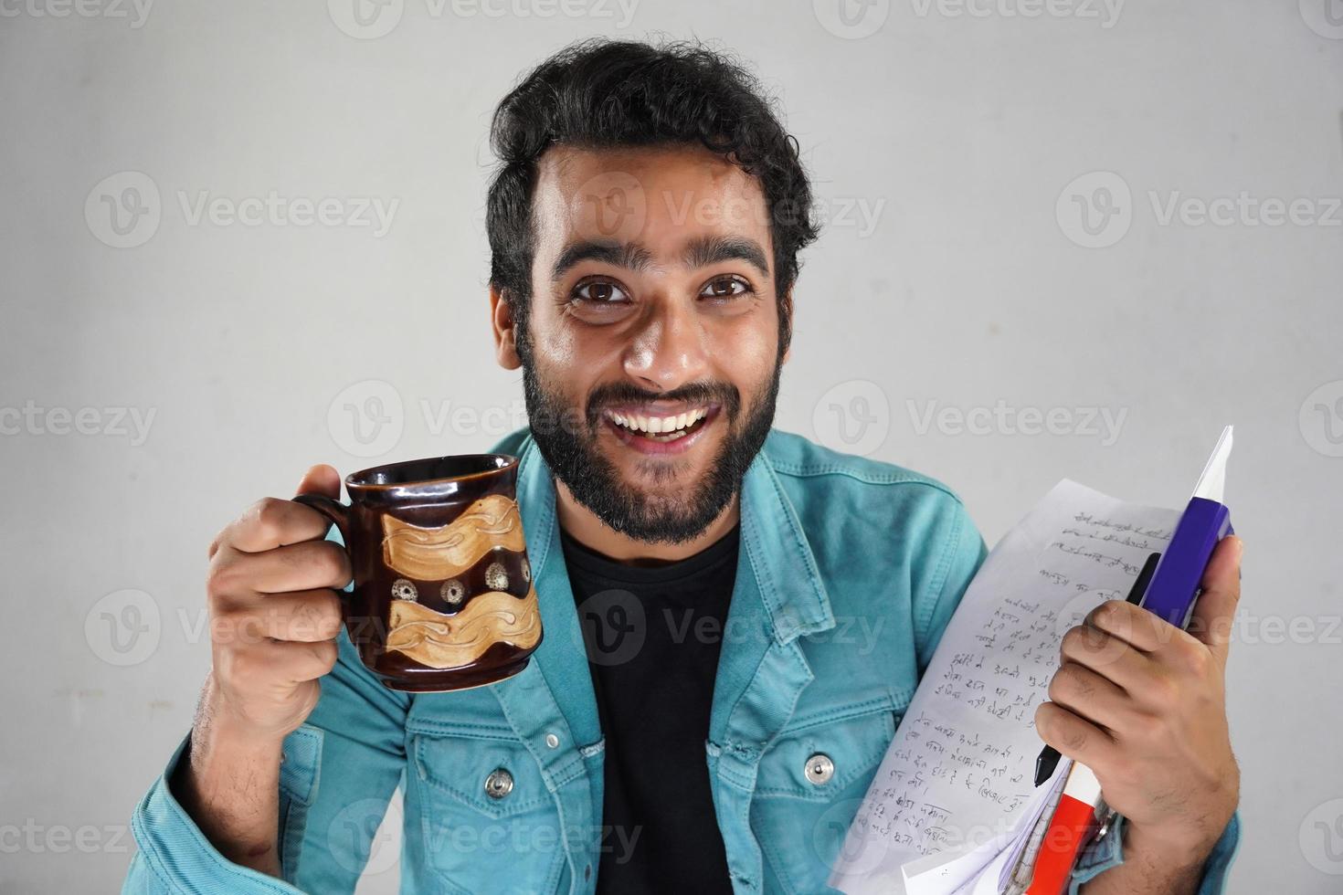 Having paper and pen and books with coffee Asian man with white background photo