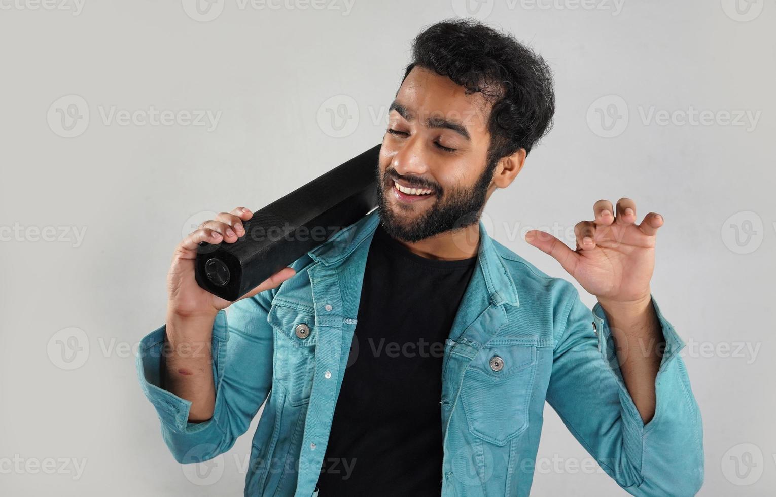 Image of man with sound bar he is happy and dancing photo