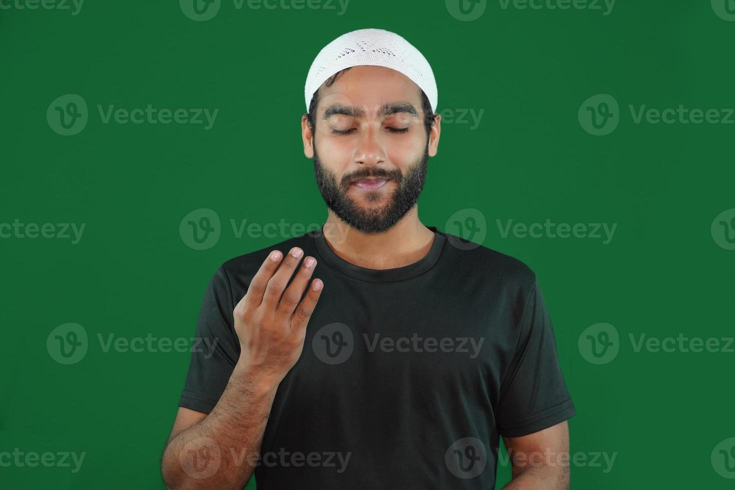 muslim boy man praying on Green screen background. photo
