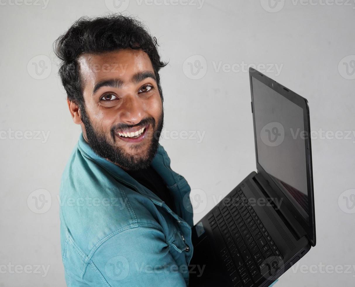 Young Indian boy with a laptop photo