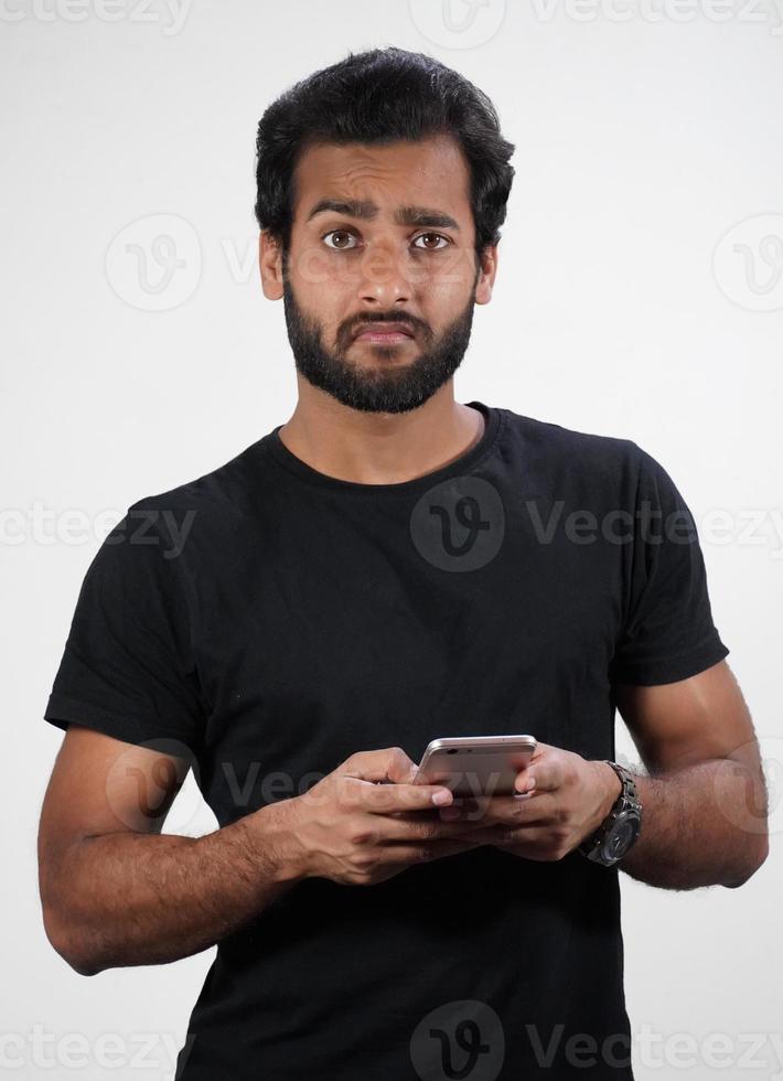 A Man using mobile and not happy in white background photo