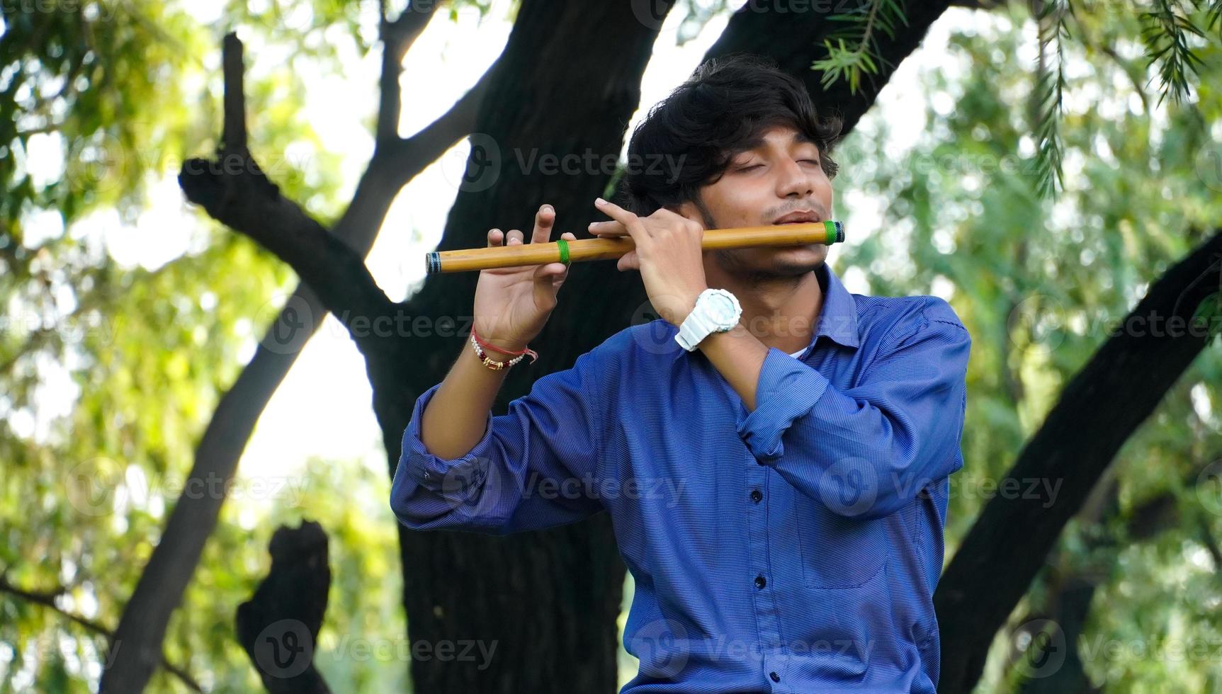 tocando la flauta bansuri instrumento de viento indio foto