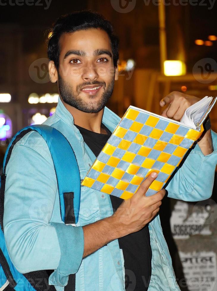 A student having new book watching camera photo