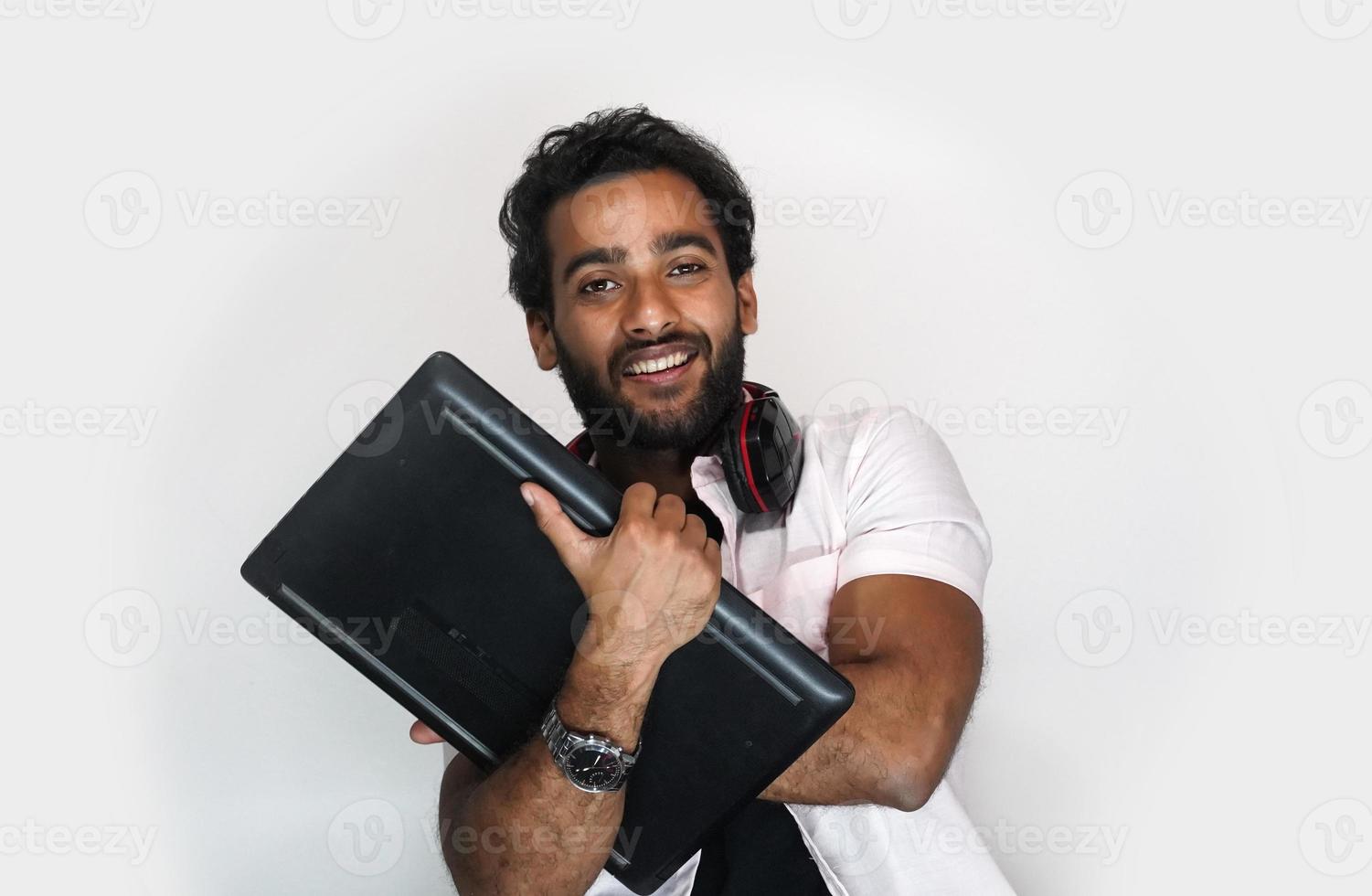 Indian college student with laptop on white background. education concept photo