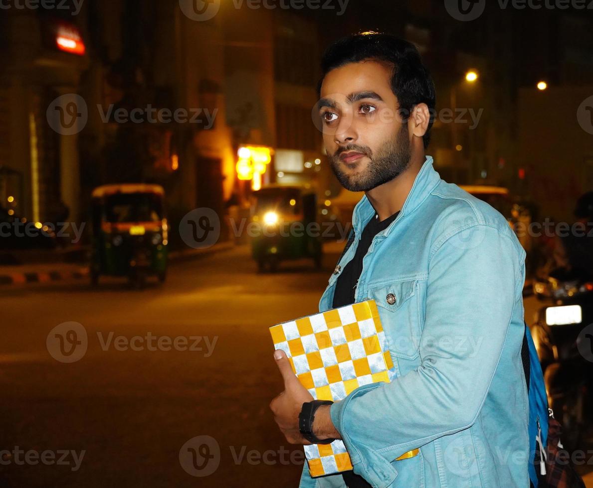 Young college student waiting for cab photo