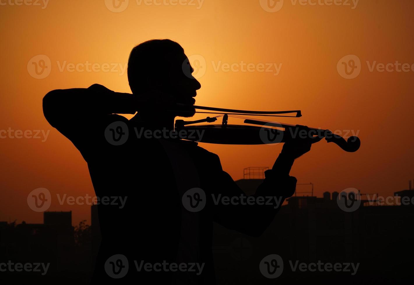 musician playing violin. Music and musical tone concept. silhouette images of man musician photo