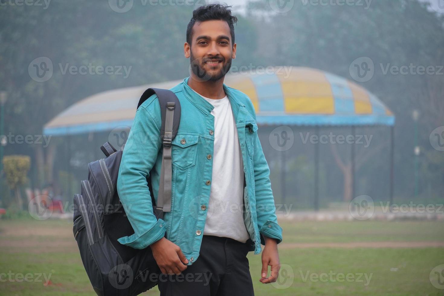 happy young student at collage campus first time standing at park photo