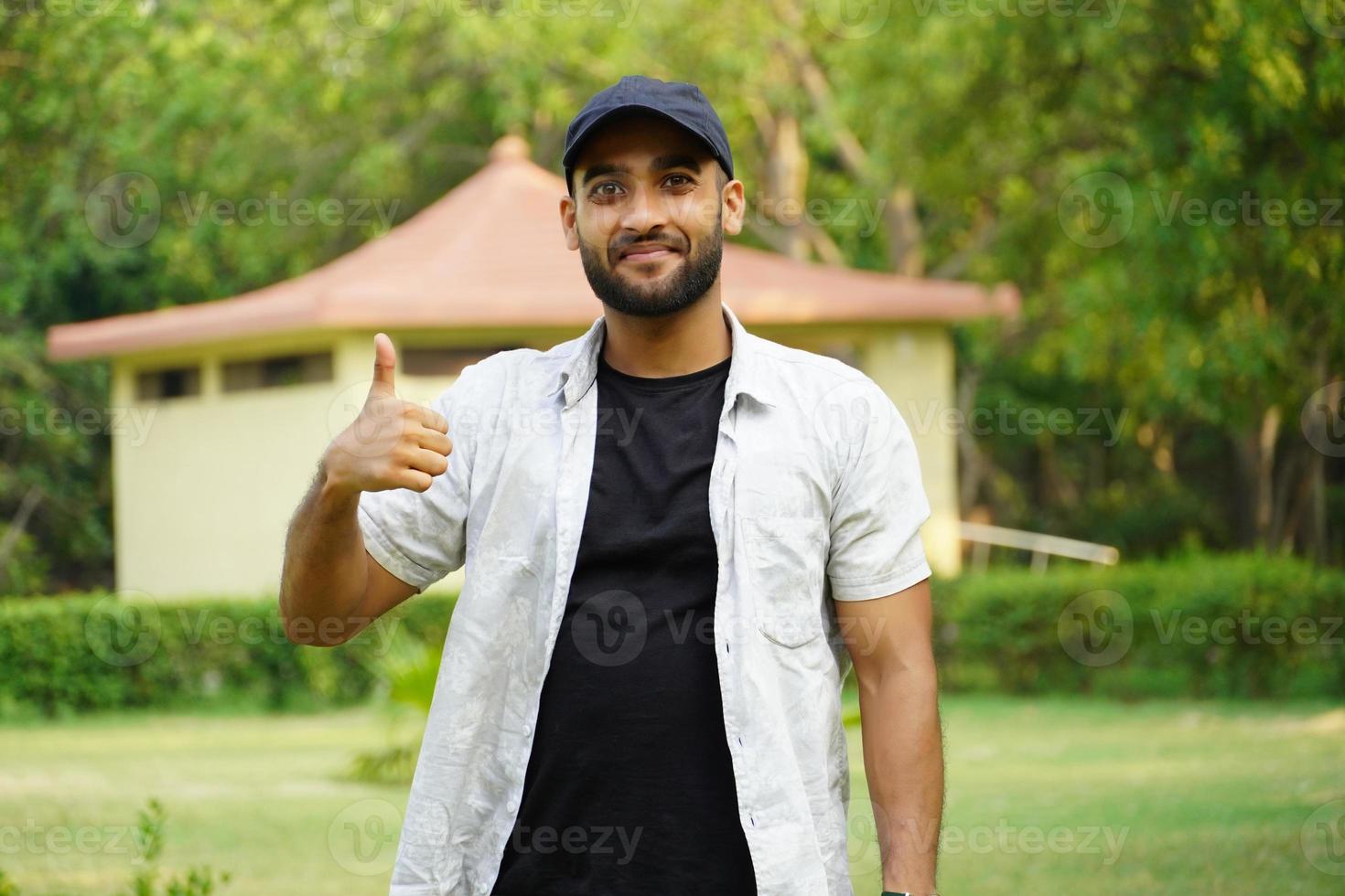 a man is giving thums up in park photo