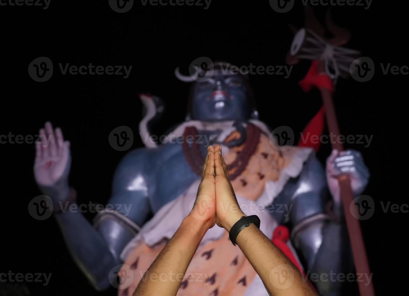 man doing prayer to Lord Shiva Statue on Ganges in Hardware .uttarakhand india. tourism photo