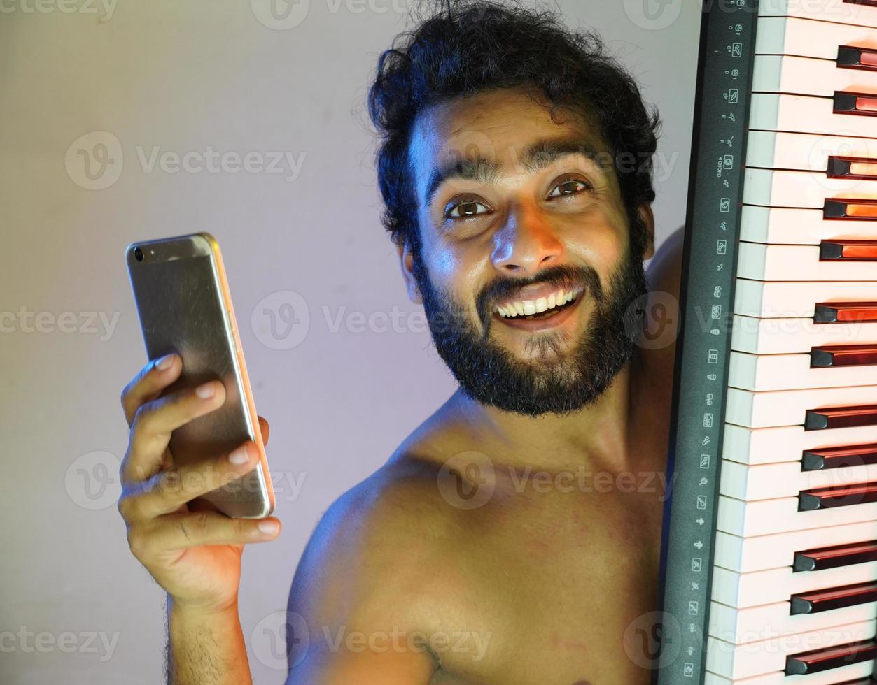 man with electronic piano and taking selfie photo