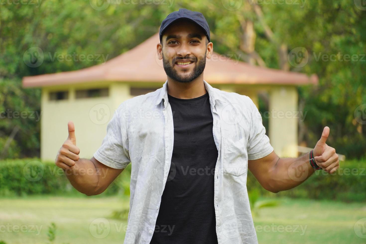 a man is giving thums up and happy photo