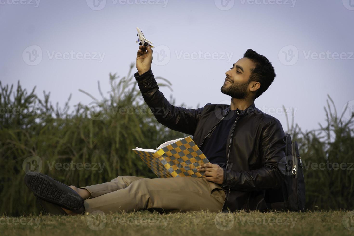 Study abroad concept man with aeroplane and books photo