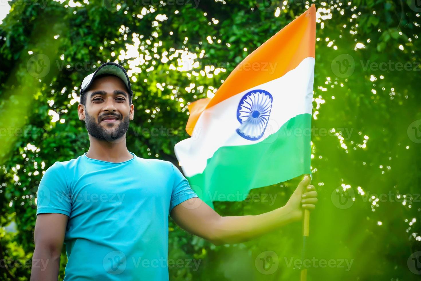 Young indian man with indian flag photo