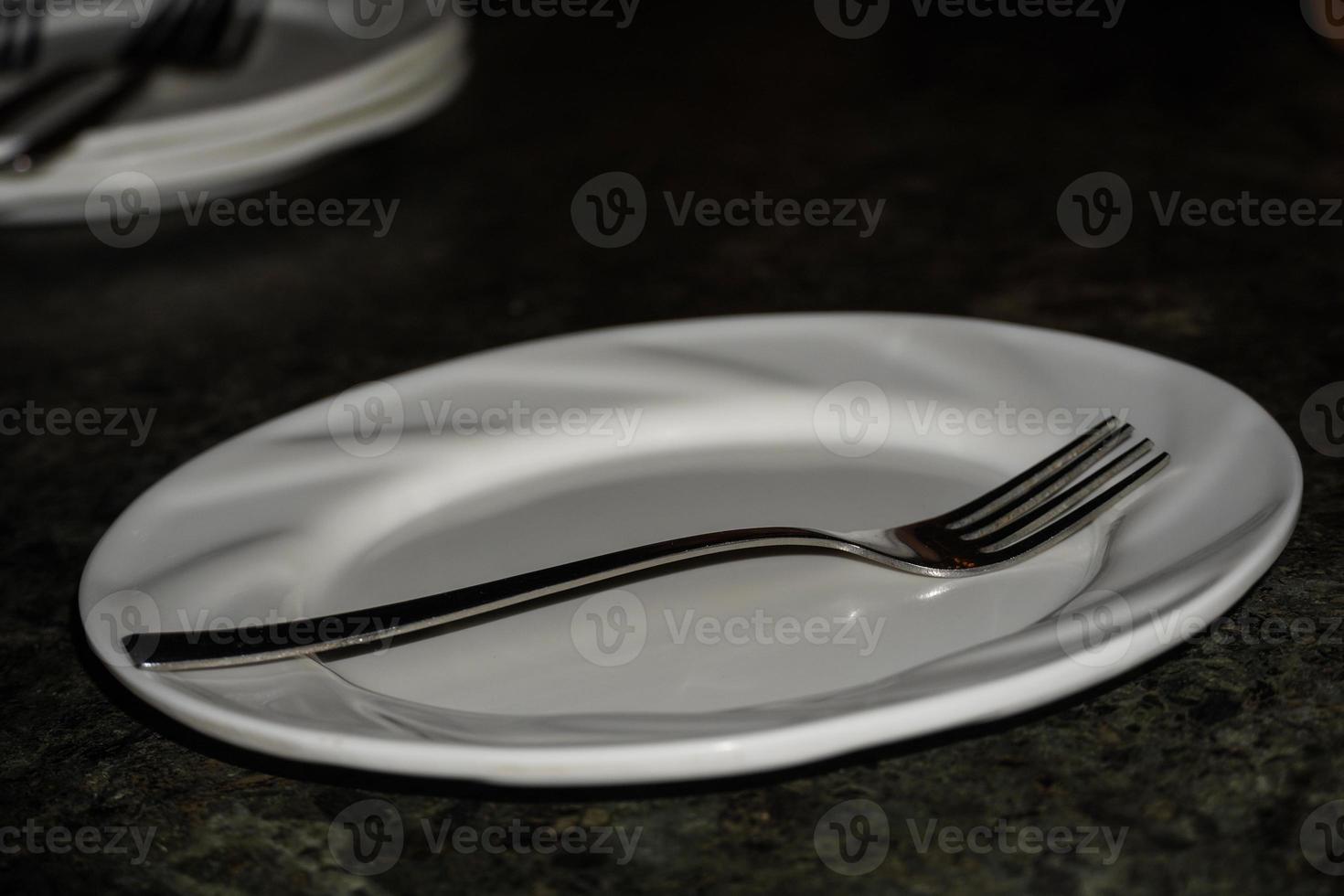 white plate with fork at restaurant photo