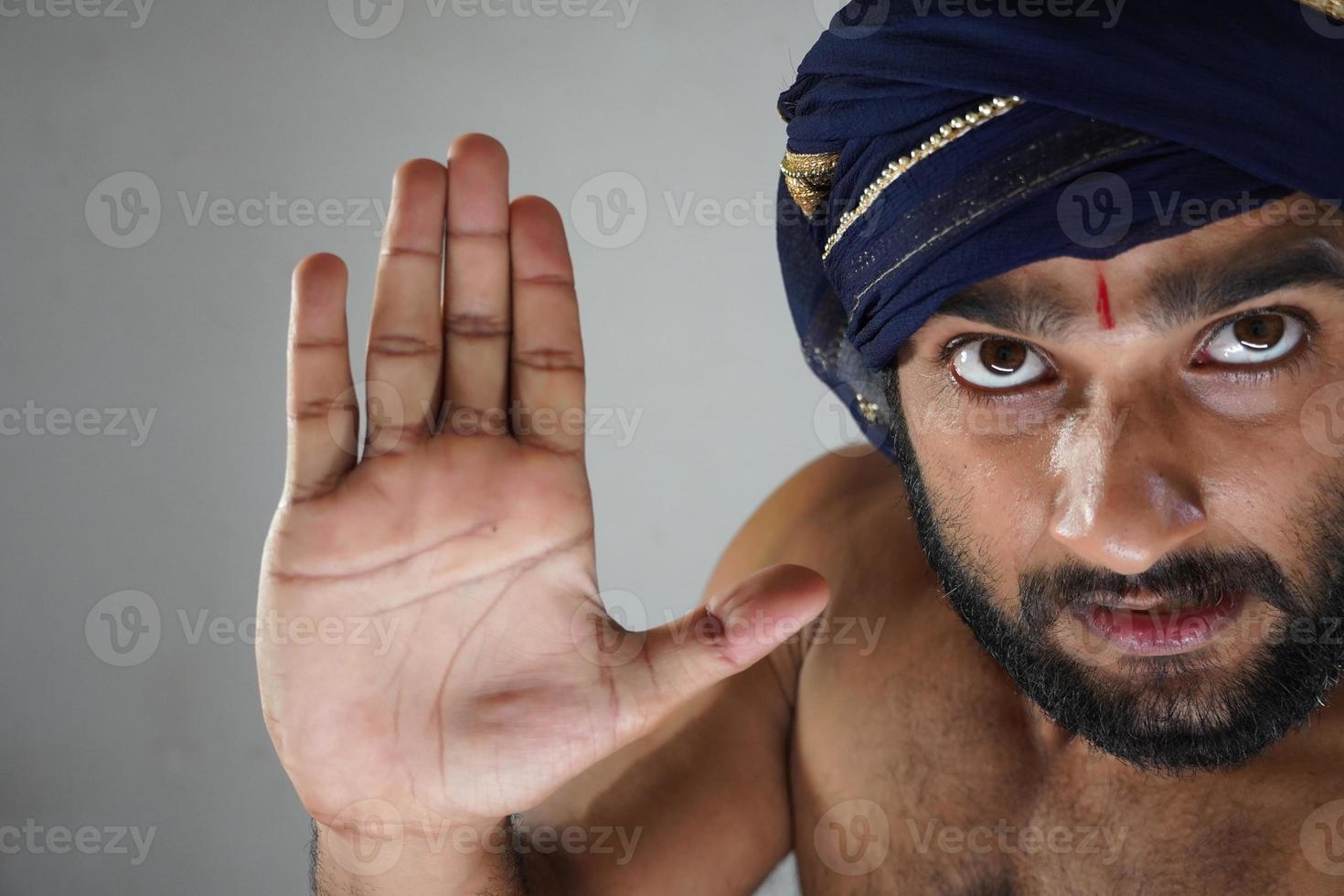 saying stop angry king images - indian man in Theater acting as a king photo