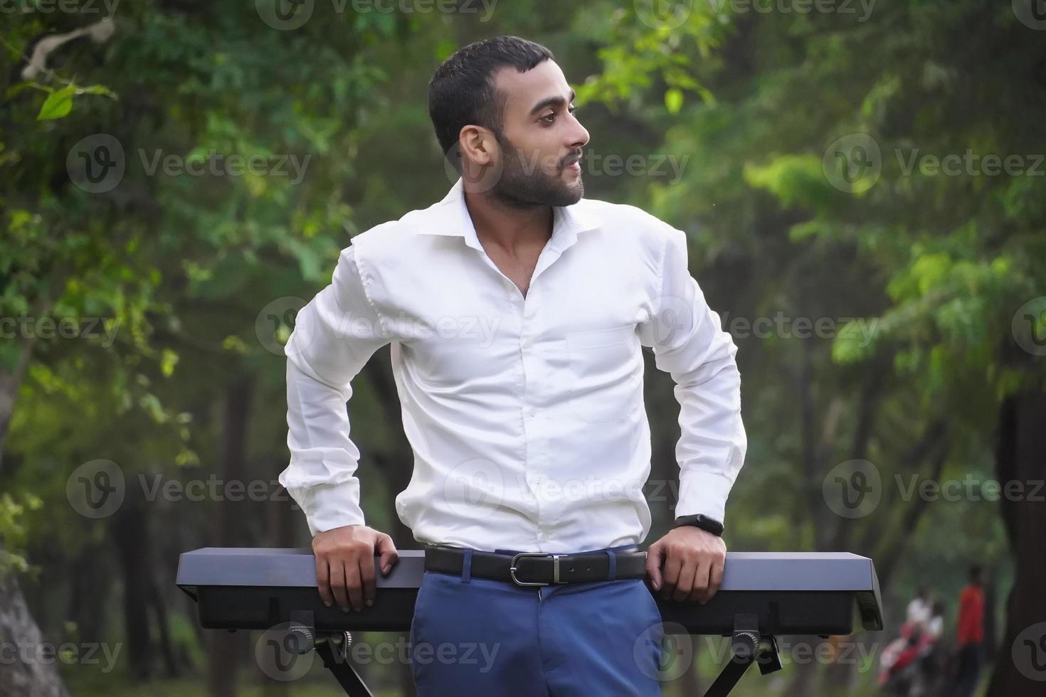 pianist in white shirt standing near playing piano photo