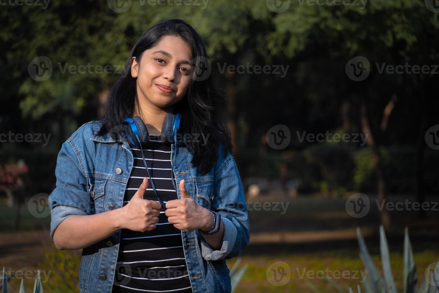 Indian girl student giving thumbs up photo