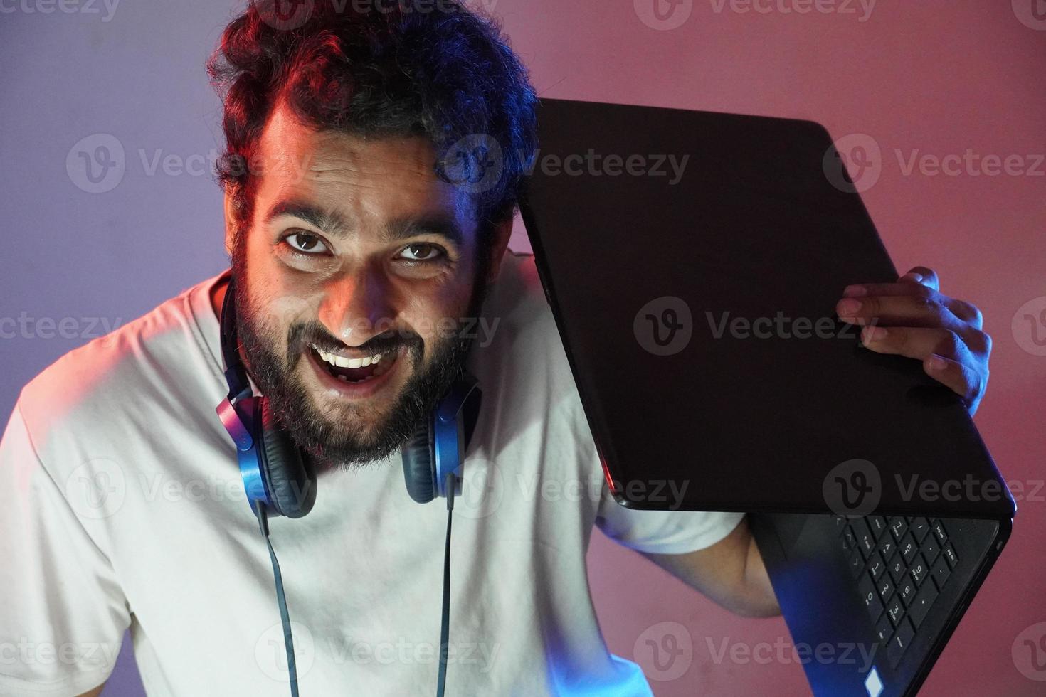 a hacker boy having laptop and and smiling face photo