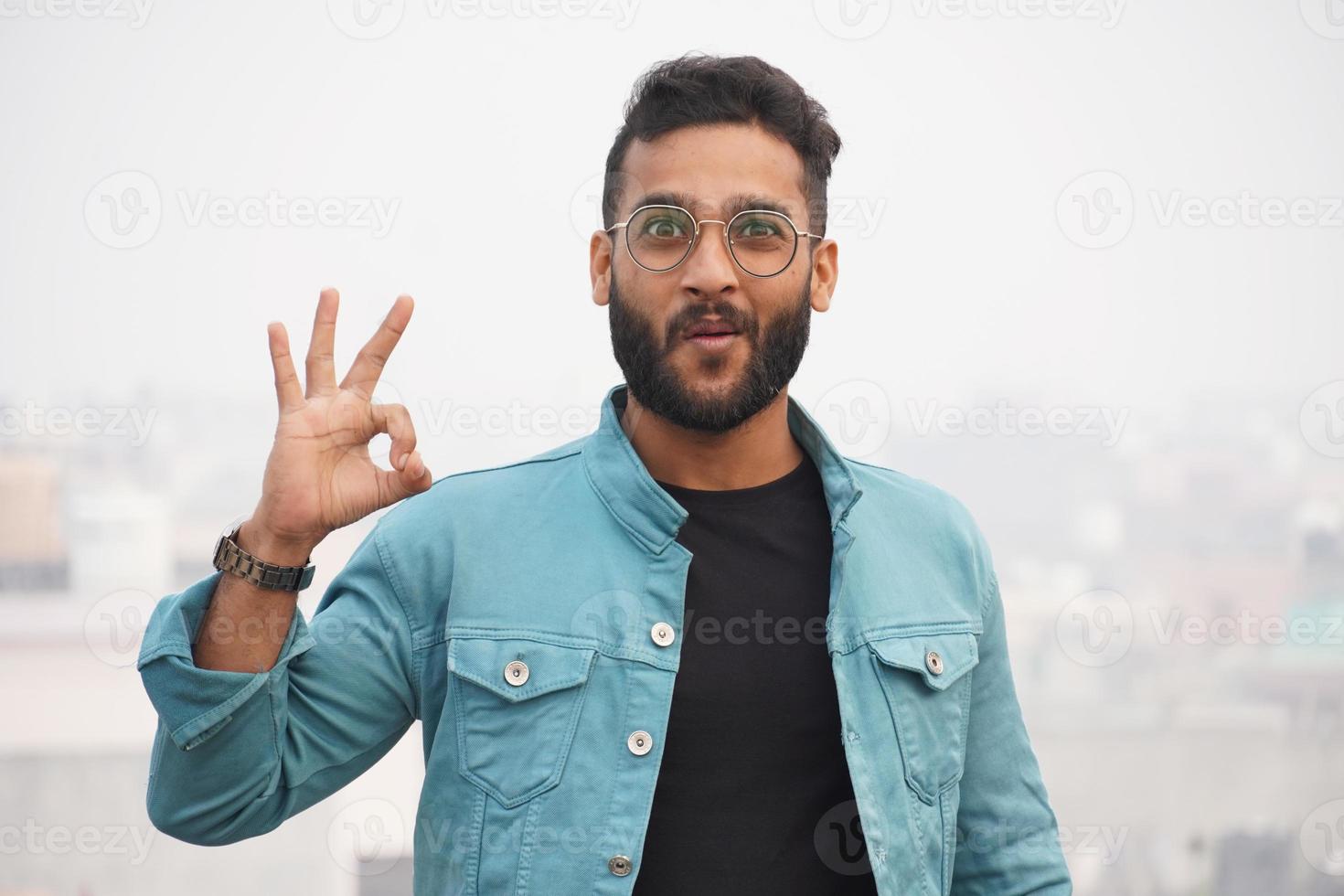 a man showing nice sign using hand photo