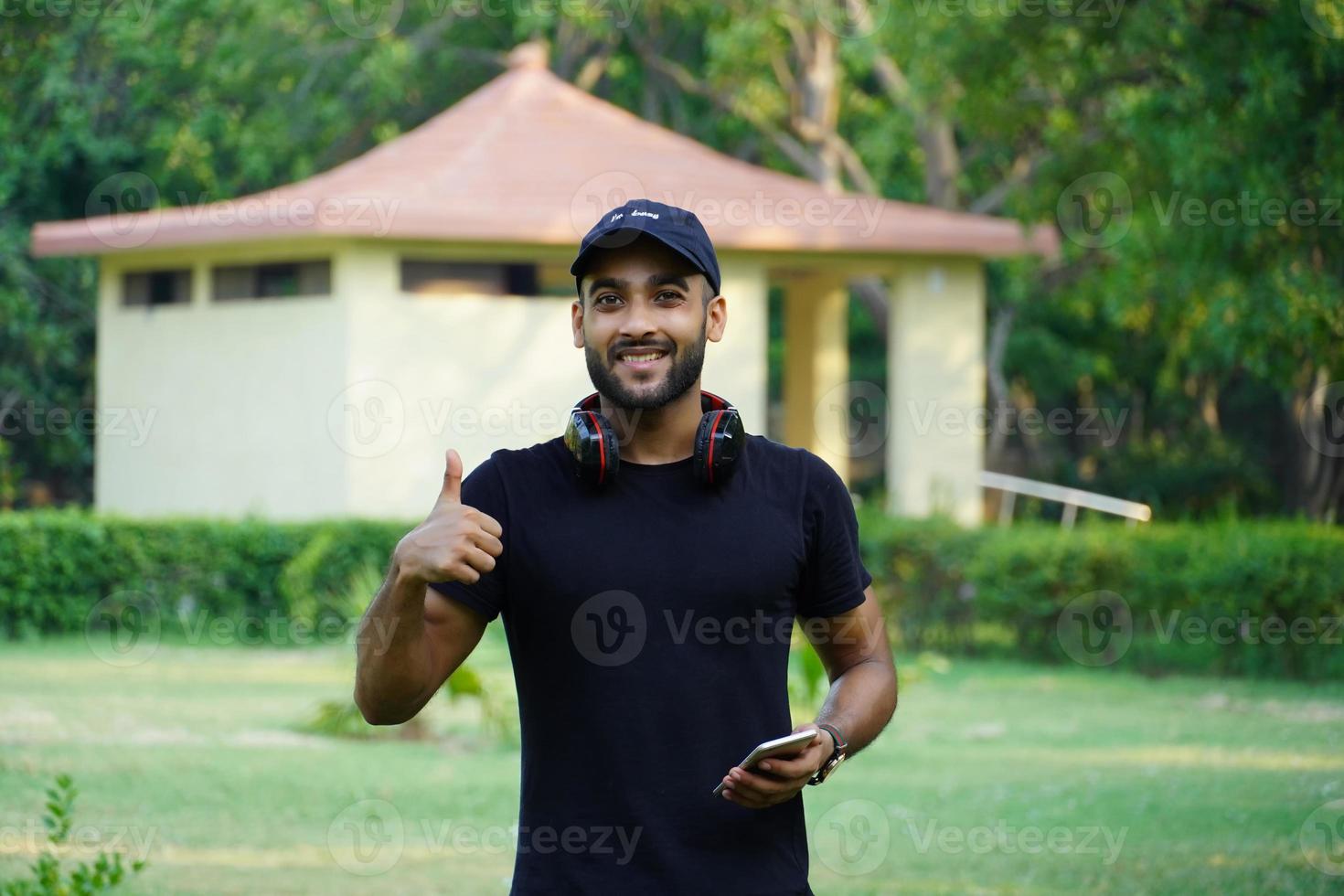 man showing thumbs up near house photo