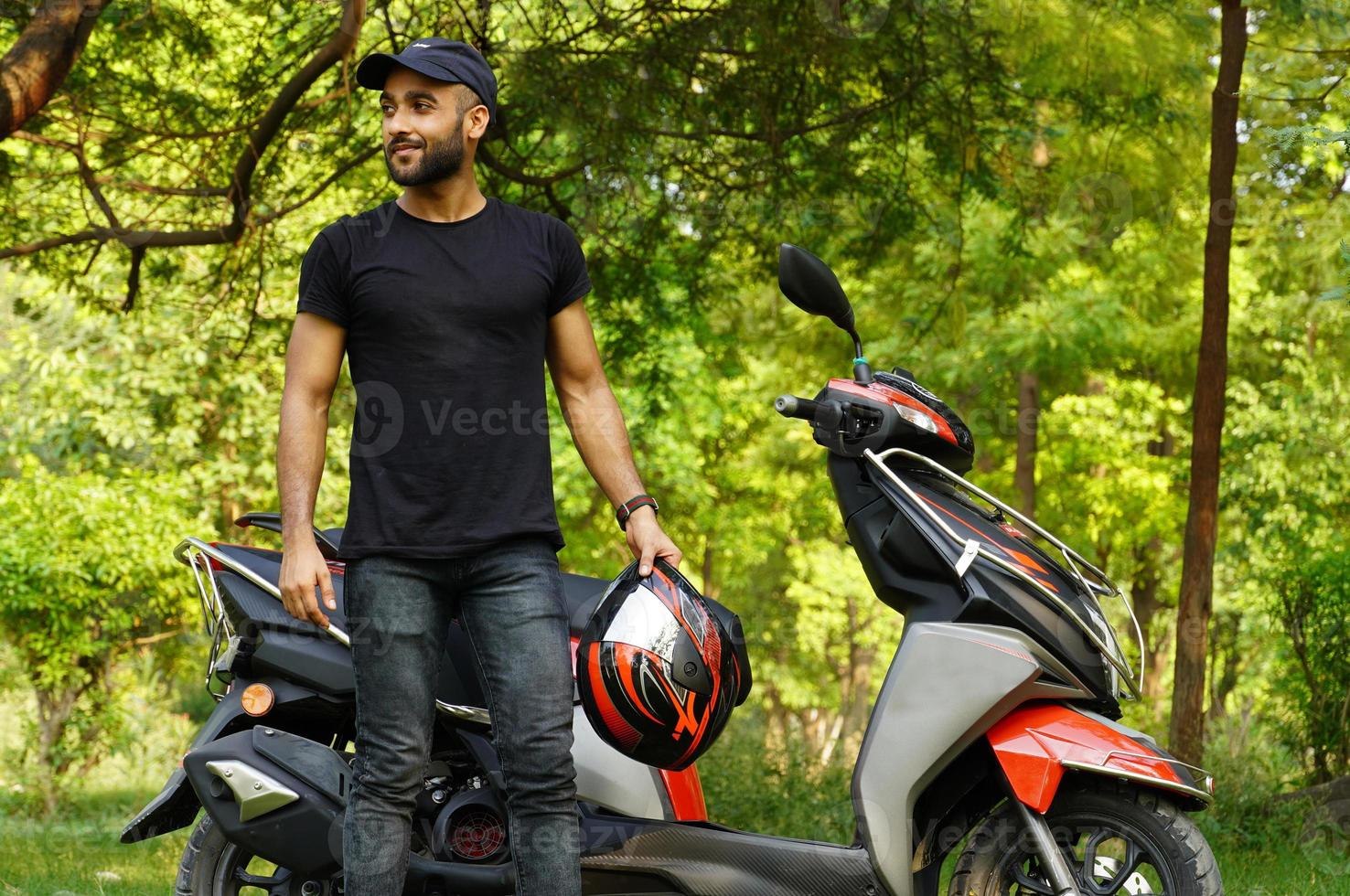 a man with his new scooter and helmet giving thums up full size image photo