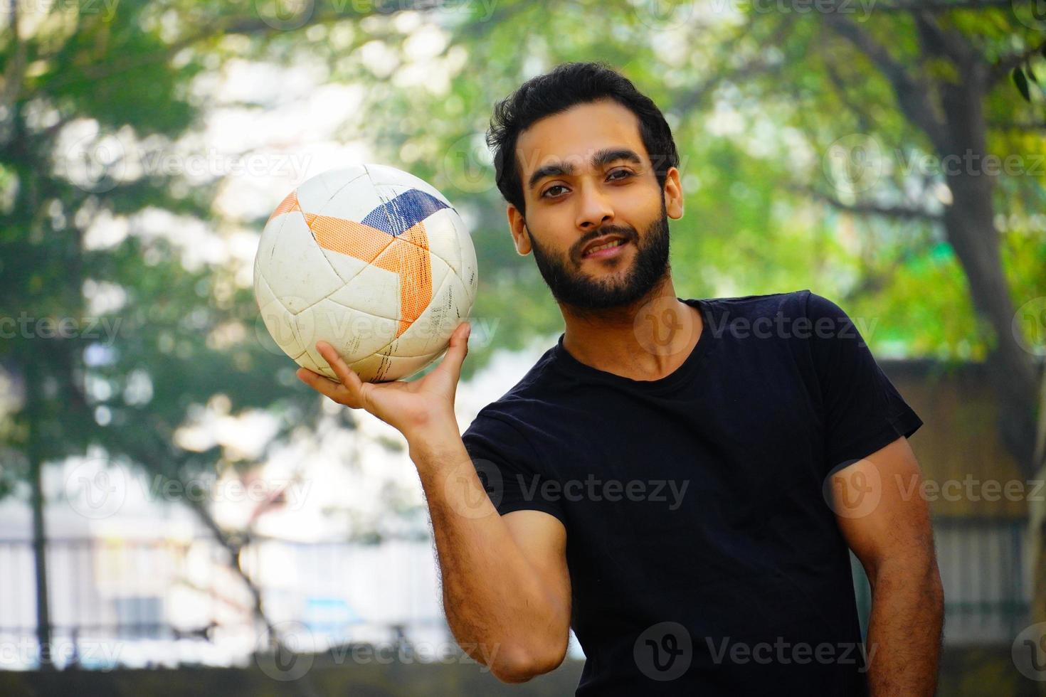 Young football player at the football field photo