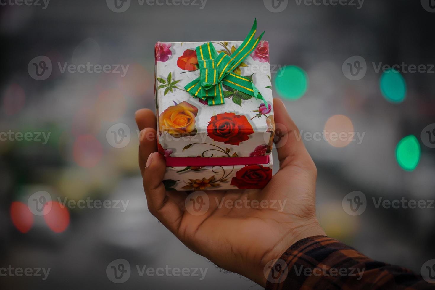 Gift box images in hand with beautiful bokeh light photo