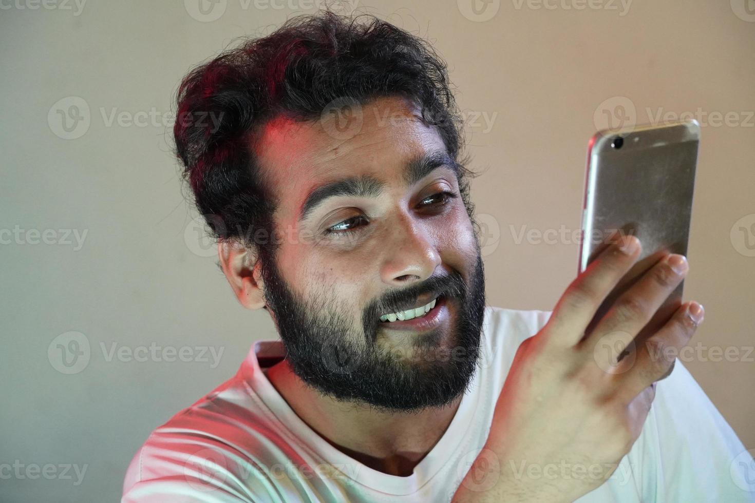 a man using mobile and happy photo