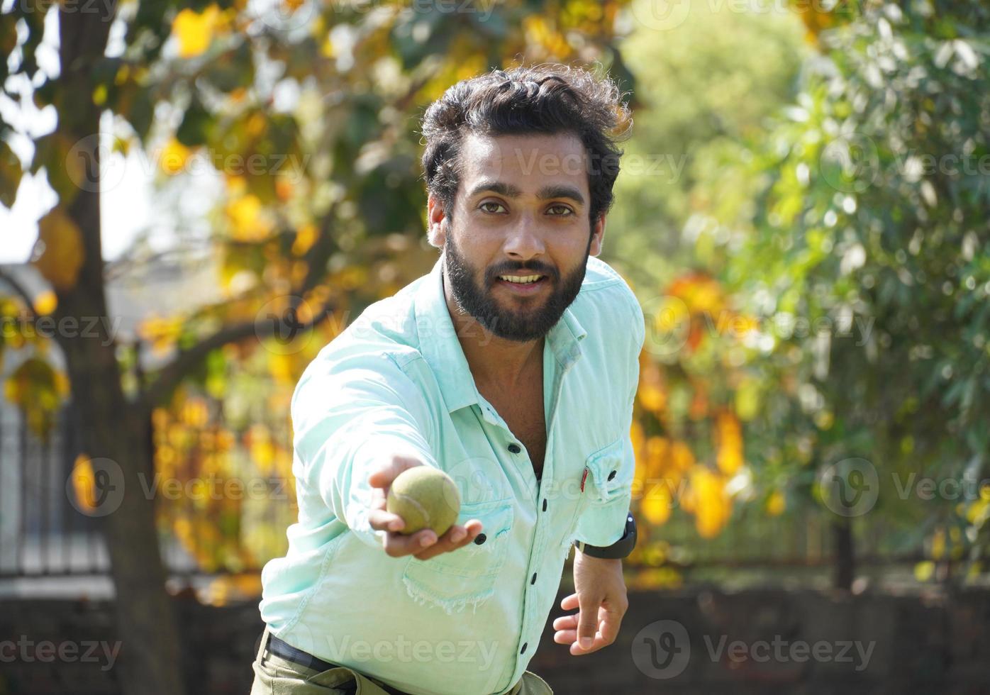 man in action with catching all in cricket match photo