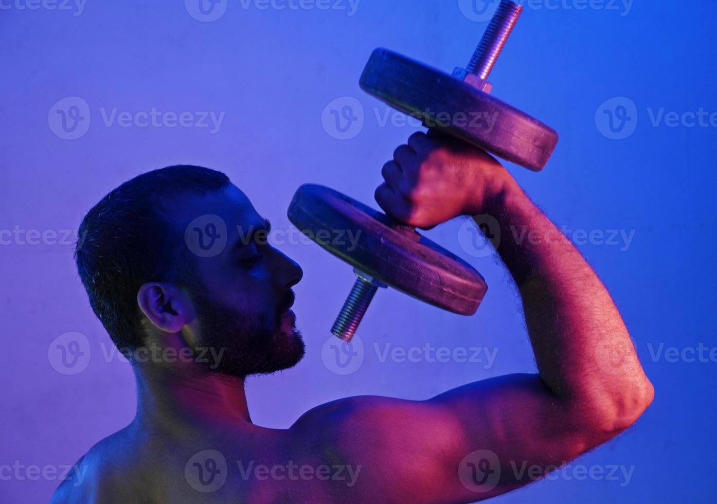 Dumbbell Man in night light photo