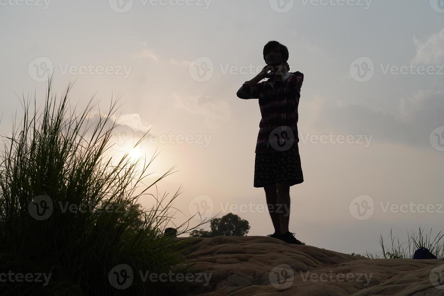 man in evening near sun standing photo