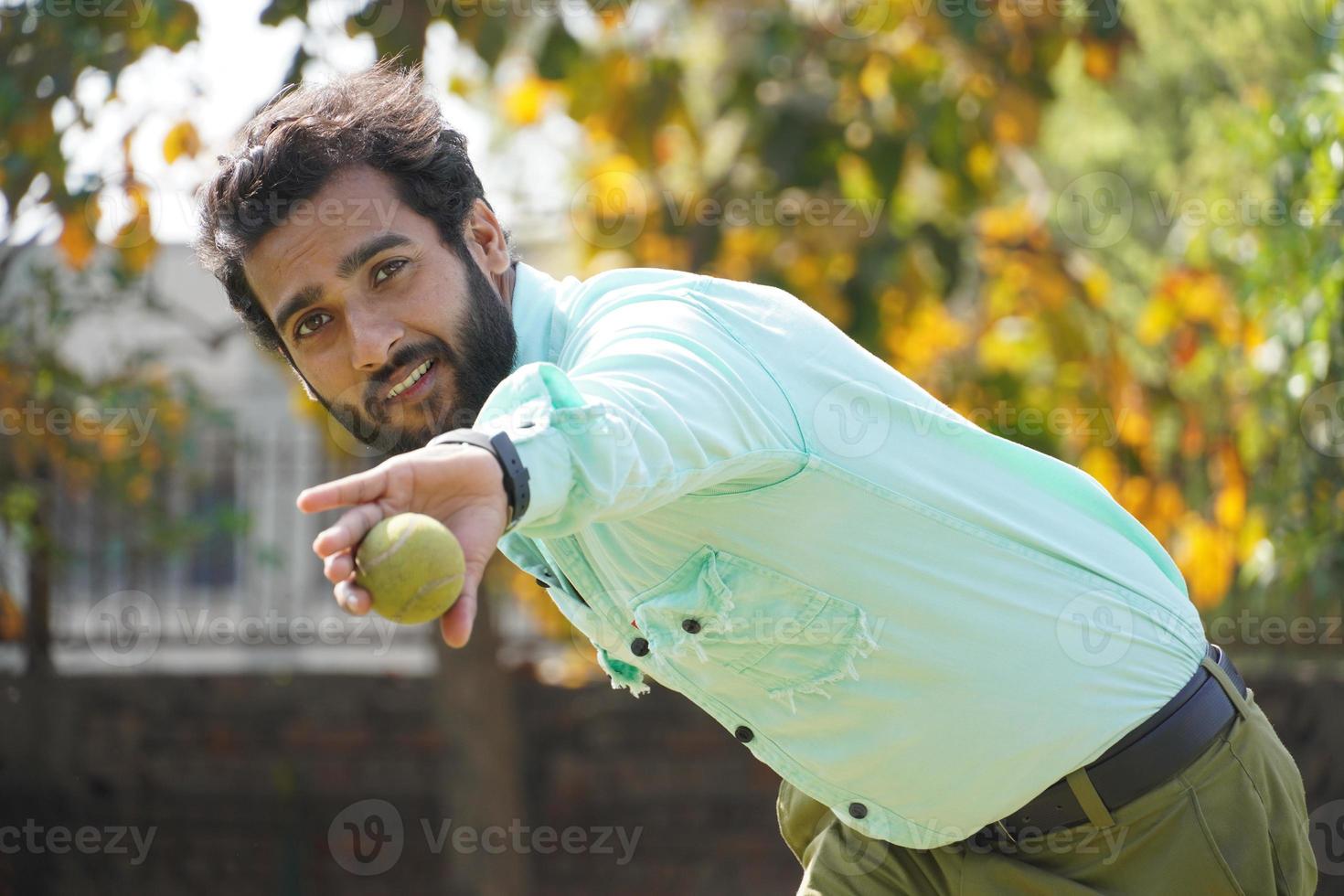 man in action with catching all in cricket match photo