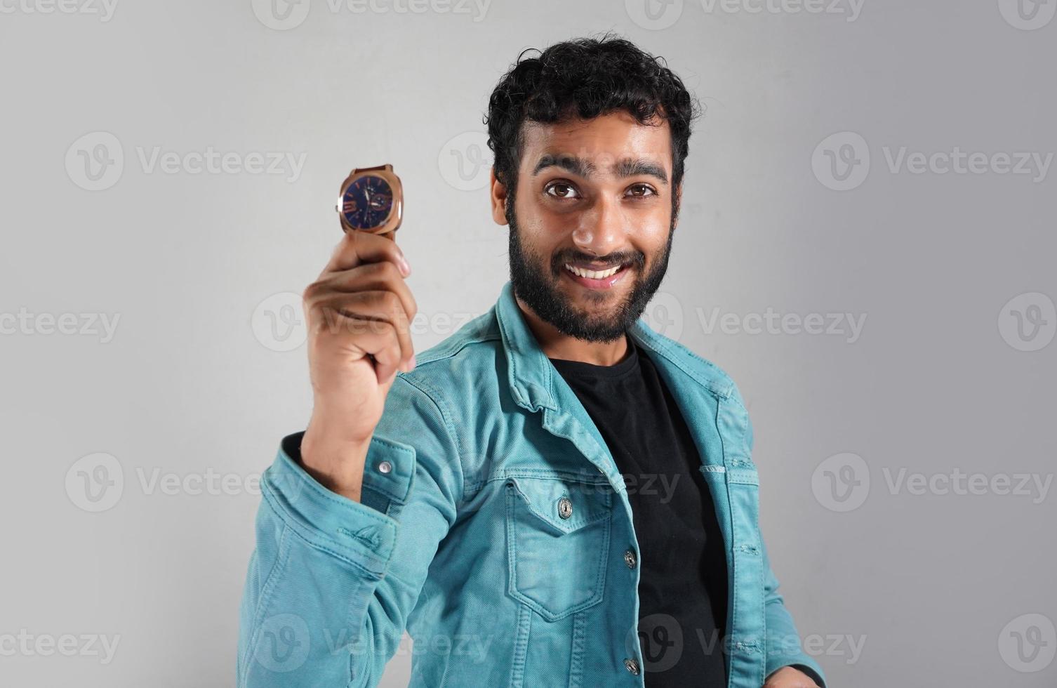 a man showing his watch in white background photo