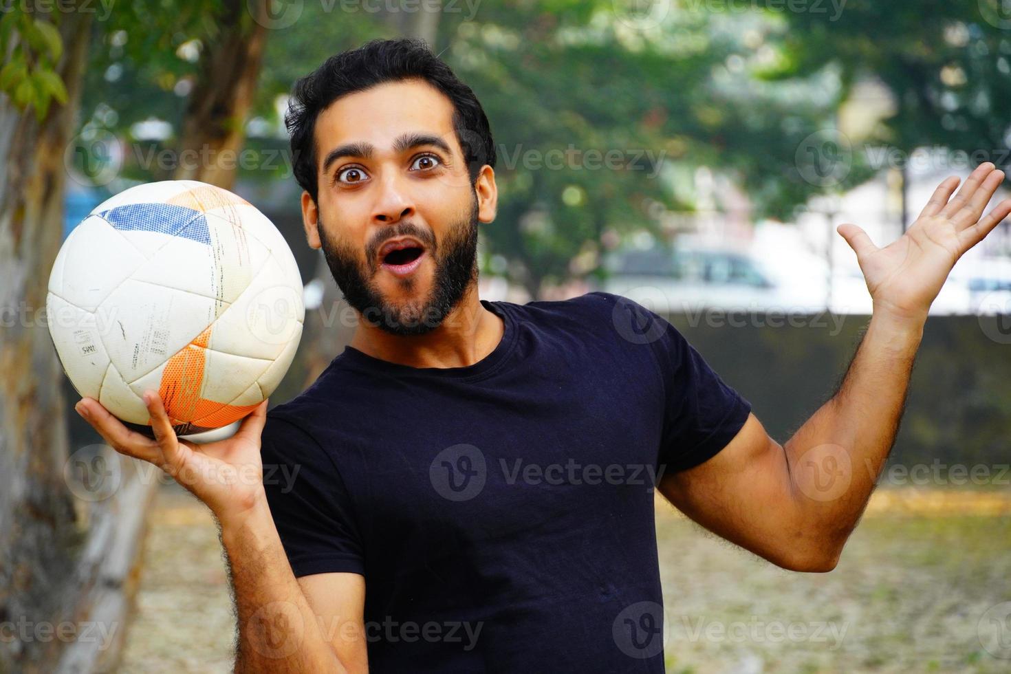 Excited boy football player Holding Ball asian footballer image photo