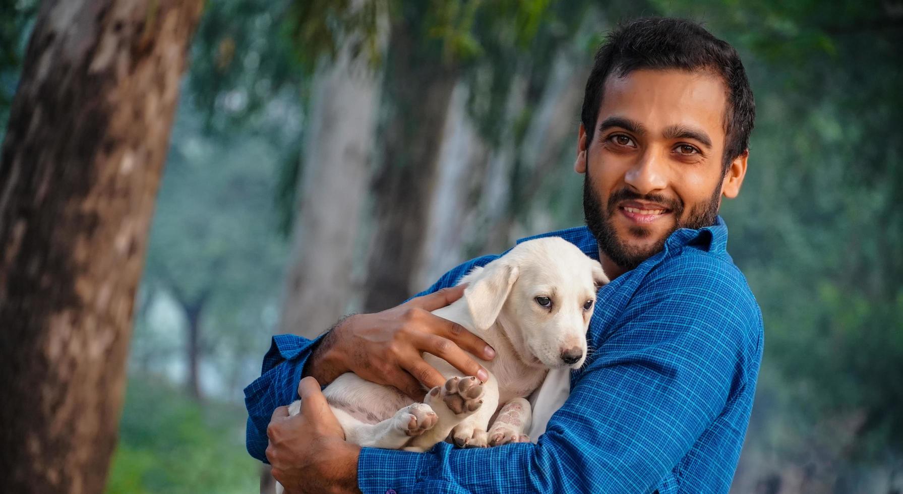 man with cute indian street dog image - cute indian street dog images with man photo