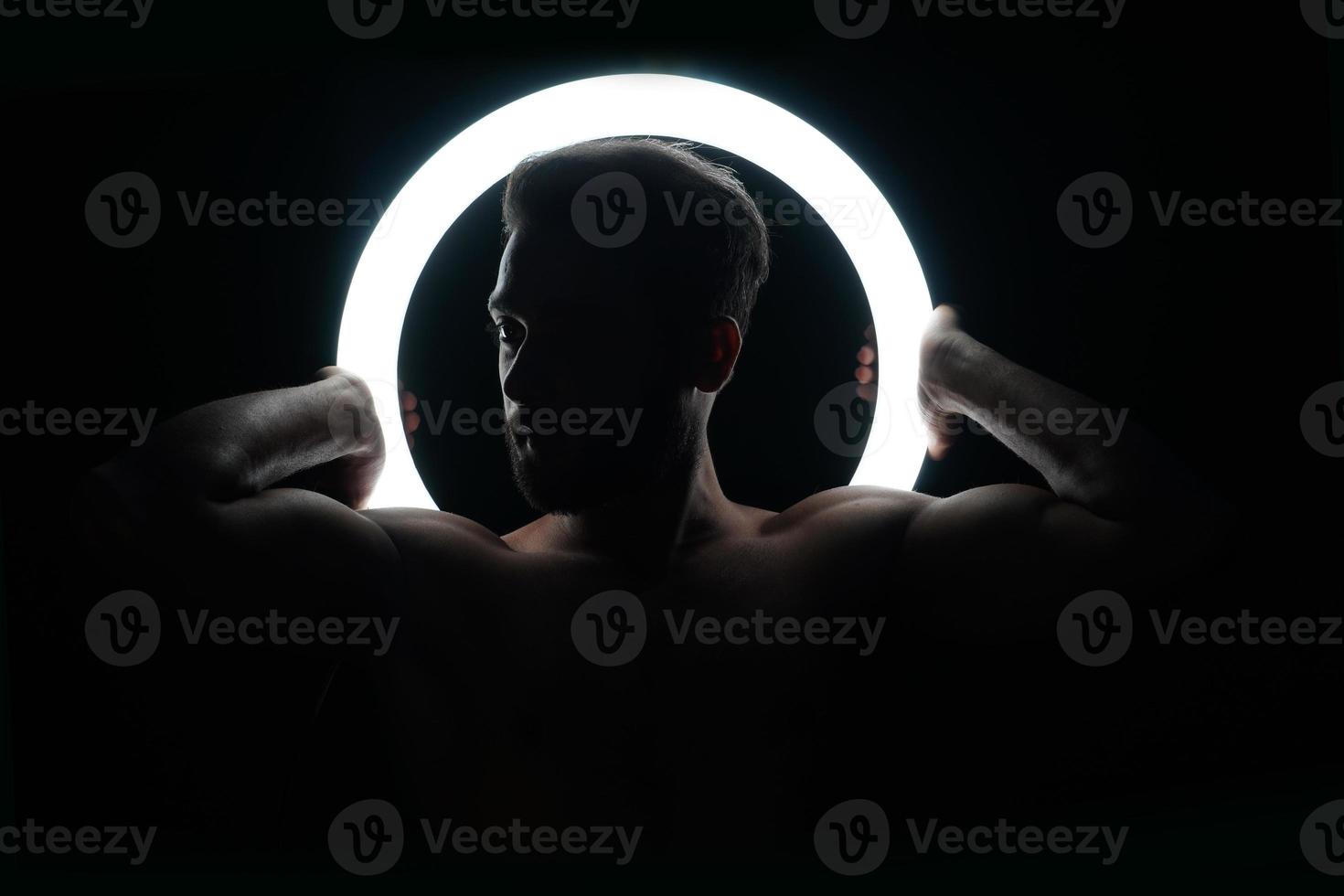 Young fit boy with ring light gym and fitness concept photo