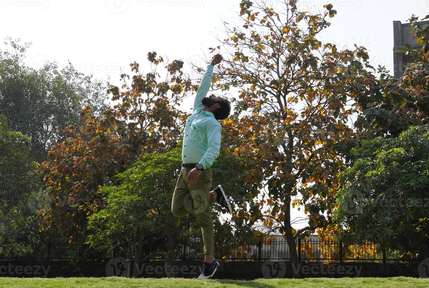 Indian Man in action of catching ball in cricket match Ground image photo