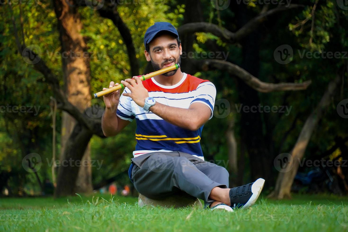 boy playing bansuri flute indian wind instrument photo