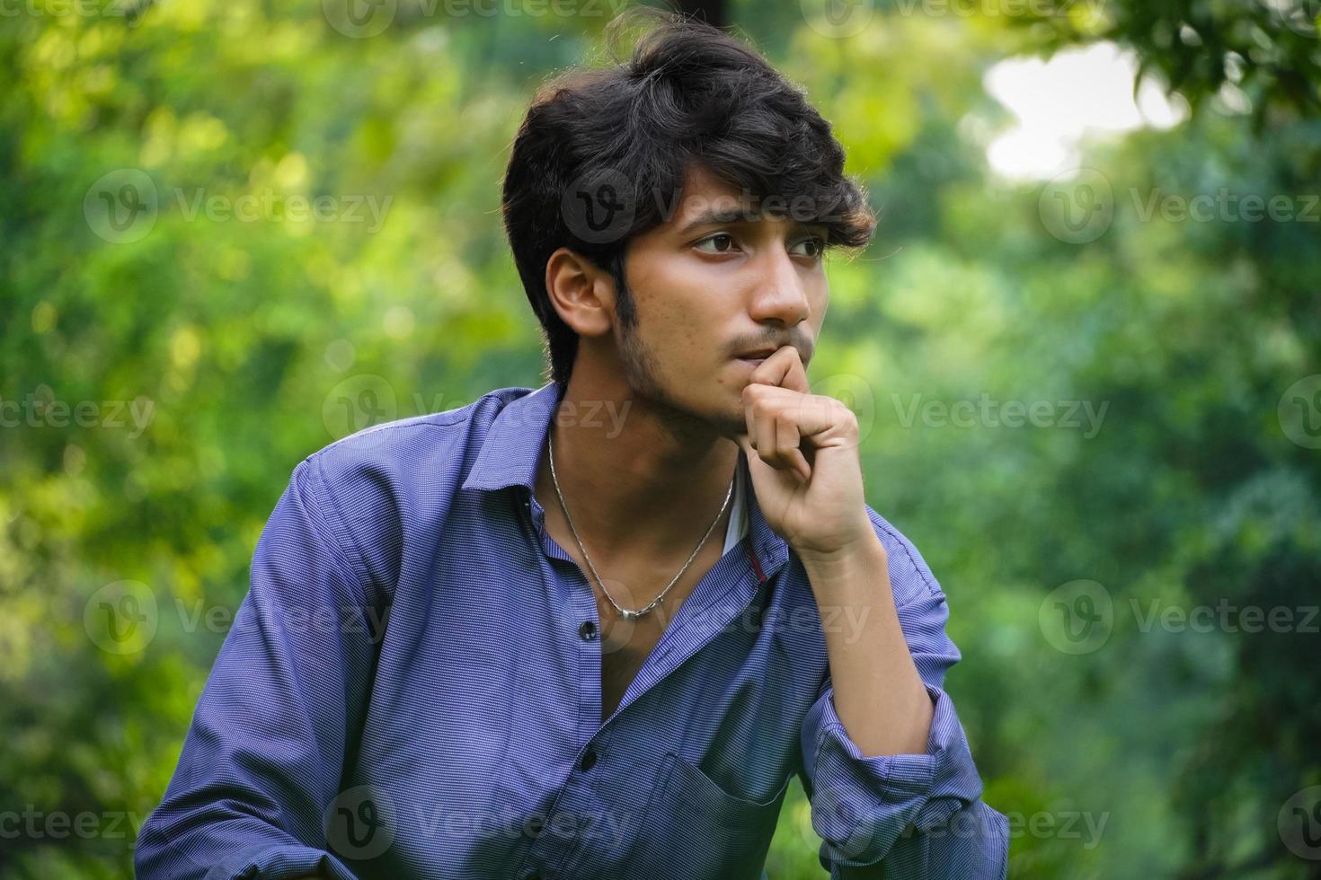 a young man in thinking photo